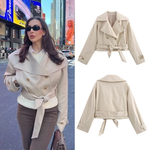 Detail view of double-breasted short trench coat with waist belt in warm beige