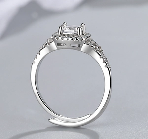Macro detail of silver adjustable ring with a square zircon center and pavé settings