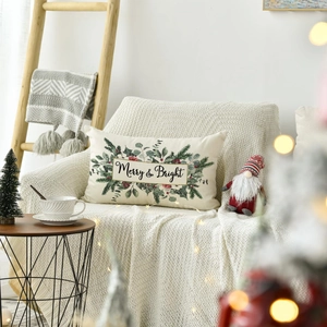 Detailed view of Merry and Bright linen pillowcase on a cozy chair with holiday decor