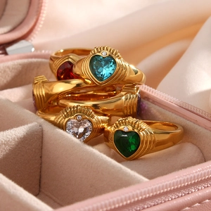 Detail of 18K gold plated Claddagh rings with heart-shaped zircon in a pink jewelry box
