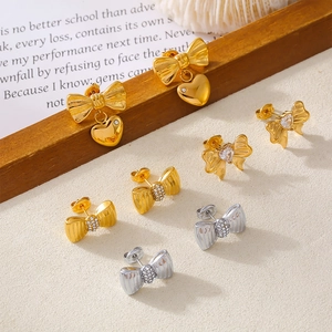 Minimalist gold and silver bow stud earrings with heart charms and micro zircon inlays