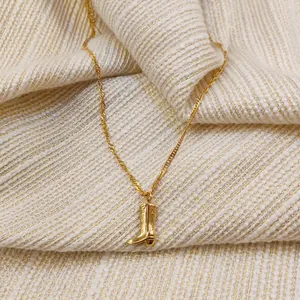 Vintage gold cowboy boot pendant necklace with intricate western engraving for women
