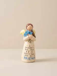 Detail of hand-painted resin angel figurine holding blue flowers with friendship quote