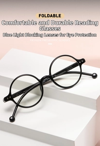 Close-up of foldable retro round frame reading glasses with wooden temples on white stand