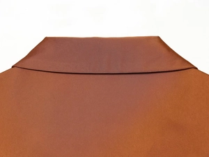 Close-up of caramel brown satin shirt collar showing high-quality twill texture fabric