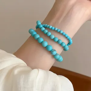 Three-piece set of synthetic turquoise beaded stretch bracelets in various bead sizes