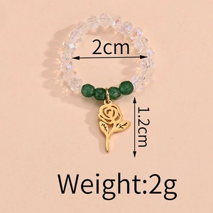 Detail view of crystal beaded ring with golden rose pendant and 2cm inner diameter size