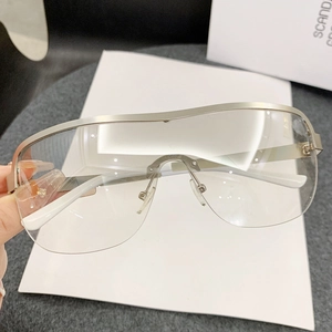 Modern oversized half-frame wrap sunglasses with silver metal trim and clear panoramic lenses