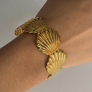 Golden shell-shaped titanium steel bracelet with a radial texture for women