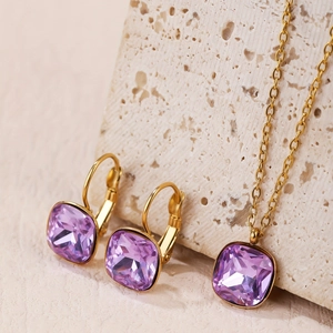 Detail view of purple square-cut zircon jewelry set with gold necklace and earrings