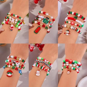 Detailed view of Christmas stretch bracelets with Santa Claus and snowflake charms