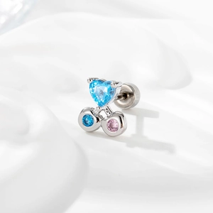 Silver steel cartilage stud with blue heart gem and pink cherry accents on white silk