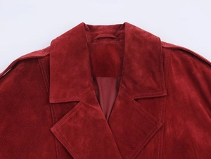 Detailed close-up of red suede jacket showing collar, epaulettes and premium stitching