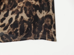 Close-up of leopard print fabric detail showing fine stitching and translucent texture