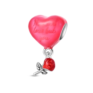 Macro detail of pink heart charm with red rose and Never love but you engraving