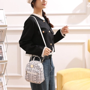 Detailed view of white snakeskin pattern leather mini backpack with detachable strap