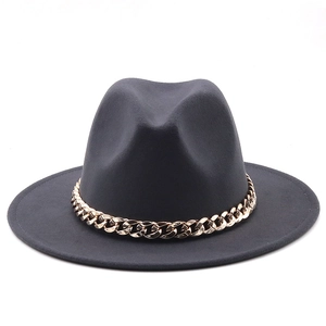 Detail of dark grey wool fedora hat featuring a chunky gold metal chain embellishment