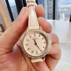 Elegant rose gold watch for women with sparkling diamond bezel and beige leather strap