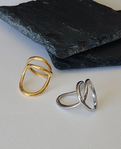 Minimalist twisted double-band rings in gold and silver finish on stone props
