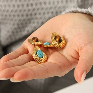 Vintage stainless steel earrings featuring turquoise and tiger eye stones in gold setting