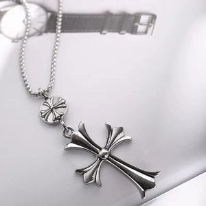 Detailed view of silver cross pendant with box chain and polished metallic finish