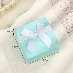 Premium light blue jewelry gift box with white silk bow and dimensions 7.3x7.4x3.8cm