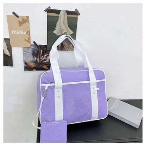 Detail of purple JK uniform bag with heart window and small matching coin purse
