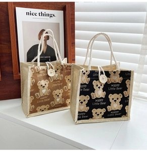 Close-up of cute cartoon bear tote bags with rustic linen texture and rope handles