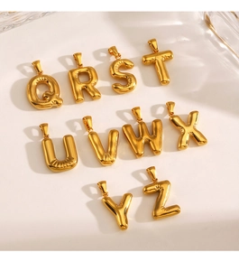 Close-up of chunky gold stainless steel alphabet letter pendants Q to Z for DIY jewelry