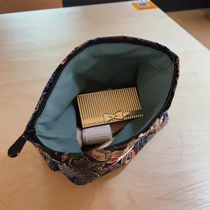 Detail showing the interior of a Chinese style brocade makeup bag with phoenix pattern