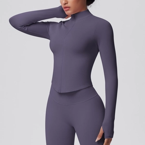 Detailed texture of seamless ribbed workout top with stand collar and thumb holes