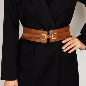 Brown wide elastic corset belt with double buckles on a stylish black blazer
