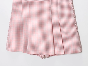 Détail du motif à carreaux vichy rose et blanc avec ourlet plissé sur la mini-jupe