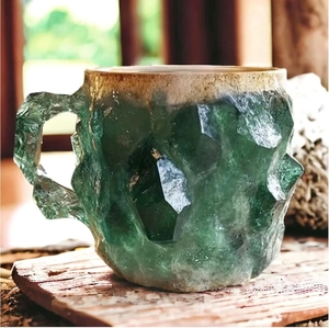 Green crystal-textured resin coffee mug with geometric facets and organic rim design