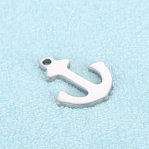 Minimalist silver stainless steel anchor pendant shown on a textured light blue background