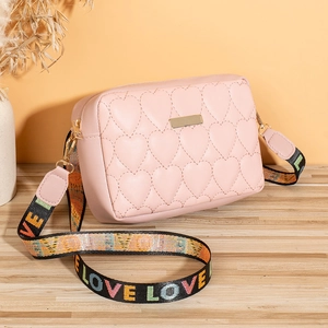Detail of pink heart-quilted crossbody bag with colorful LOVE letter wide strap and gold hardware