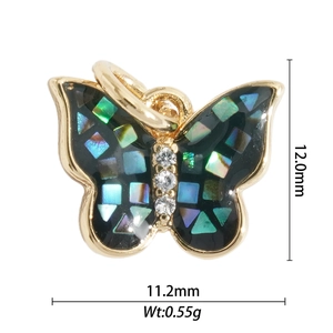 Macro shot of 12mm gold butterfly charm with iridescent shell inlay and tiny crystals