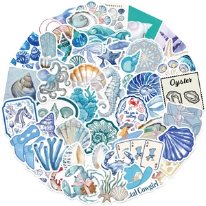 Close-up of blue coastal cowgirl stickers featuring shells, starfish and coral elements