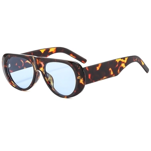 Detail view of tortoiseshell oversized sunglasses with light blue translucent lenses