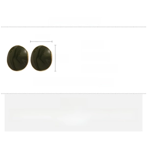 Detail view of oval dark green enamel earrings with gold-plated copper edges and silver needles