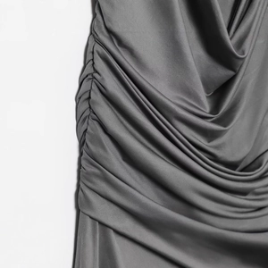 Fashionable grey ruched maxi dress with metallic accents and draped silk-like fabric