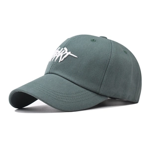 Detail of dark green cotton baseball cap with 3D white embroidery and curved brim