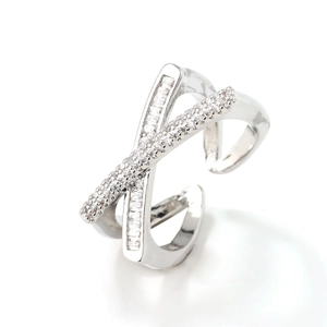 Elegant silver criss-cross ring with baguette and pavé cubic zirconia on white background