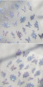 Detailed macro view of 3D holographic laser butterfly nail stickers with embossed texture
