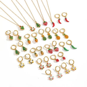 Golden stainless steel jewelry set featuring colorful enamel fruit and Christmas charms