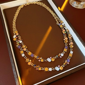 Detail of double-layer vintage necklace with colorful crystals on dark jewelry box