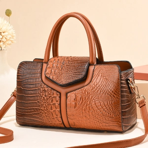 Brown crocodile embossed Boston pillow handbag with dual handles and shoulder strap