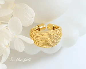 Detail of multi-layer gold plated ring with beaded texture and elegant autumn styling