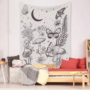 Detail of bohemian black and white tapestry with mushrooms, flowers, and moon hanging over bed