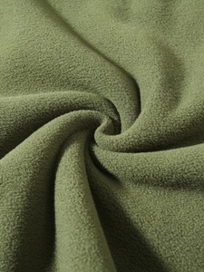 Close-up of soft army green coral fleece fabric texture showing warmth and thickness